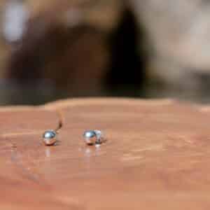Sterling silver balls on wooden surface