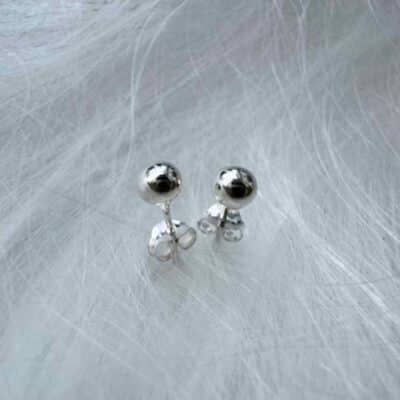 Sterling Silver Ball Earrings on a flossy background